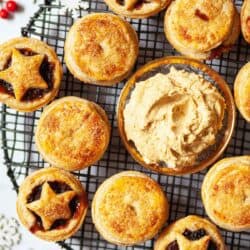 Close up image of puff pastry mince pies with advocaat butter on a cooling rack.