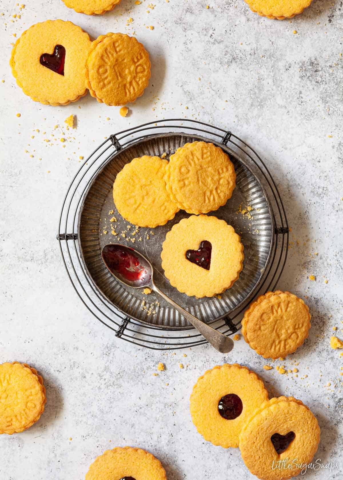 Overhead view of custard cream biscuits filled with jam.