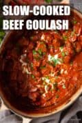 Beef goulash in a dutch oven with text overlay.