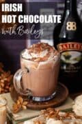 Baileys Irish hot chocolate with cream in a glass mug with text overlay.