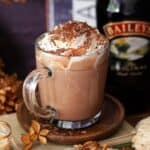 Close up of Baileys hot chocolate with whipped cream and chocolate flakes.