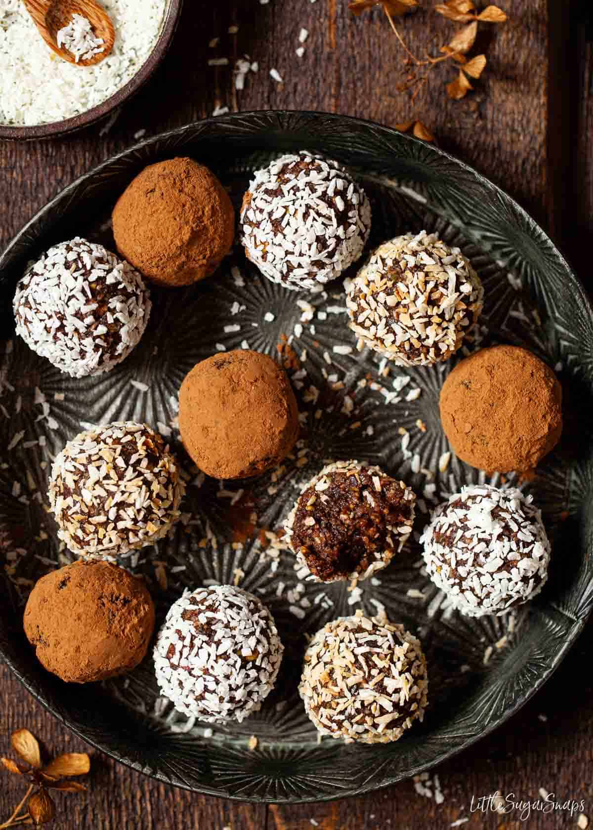 A mixture of chocolate coconut date balls in a baking tin.