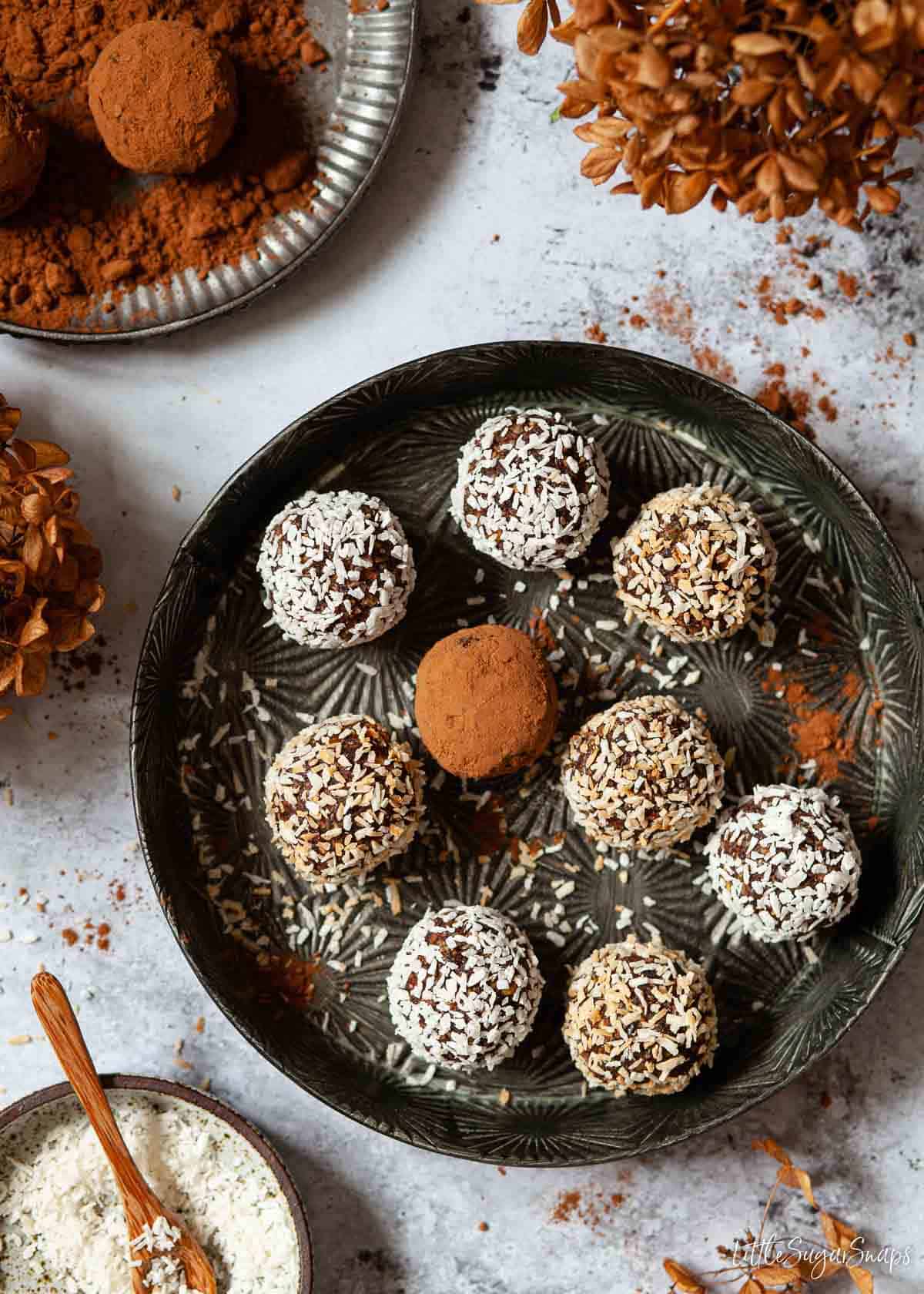 Chocolate date balls covered in cocoa powder and coconut.