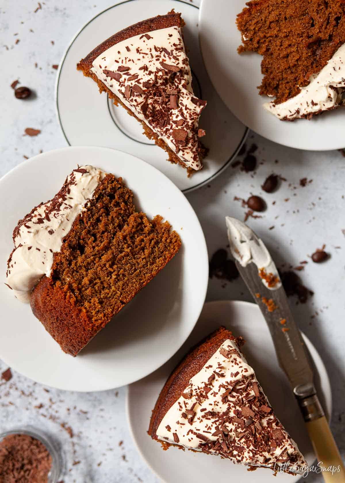 Slices of Irish coffee cake with Baileys whipped cream on plates.