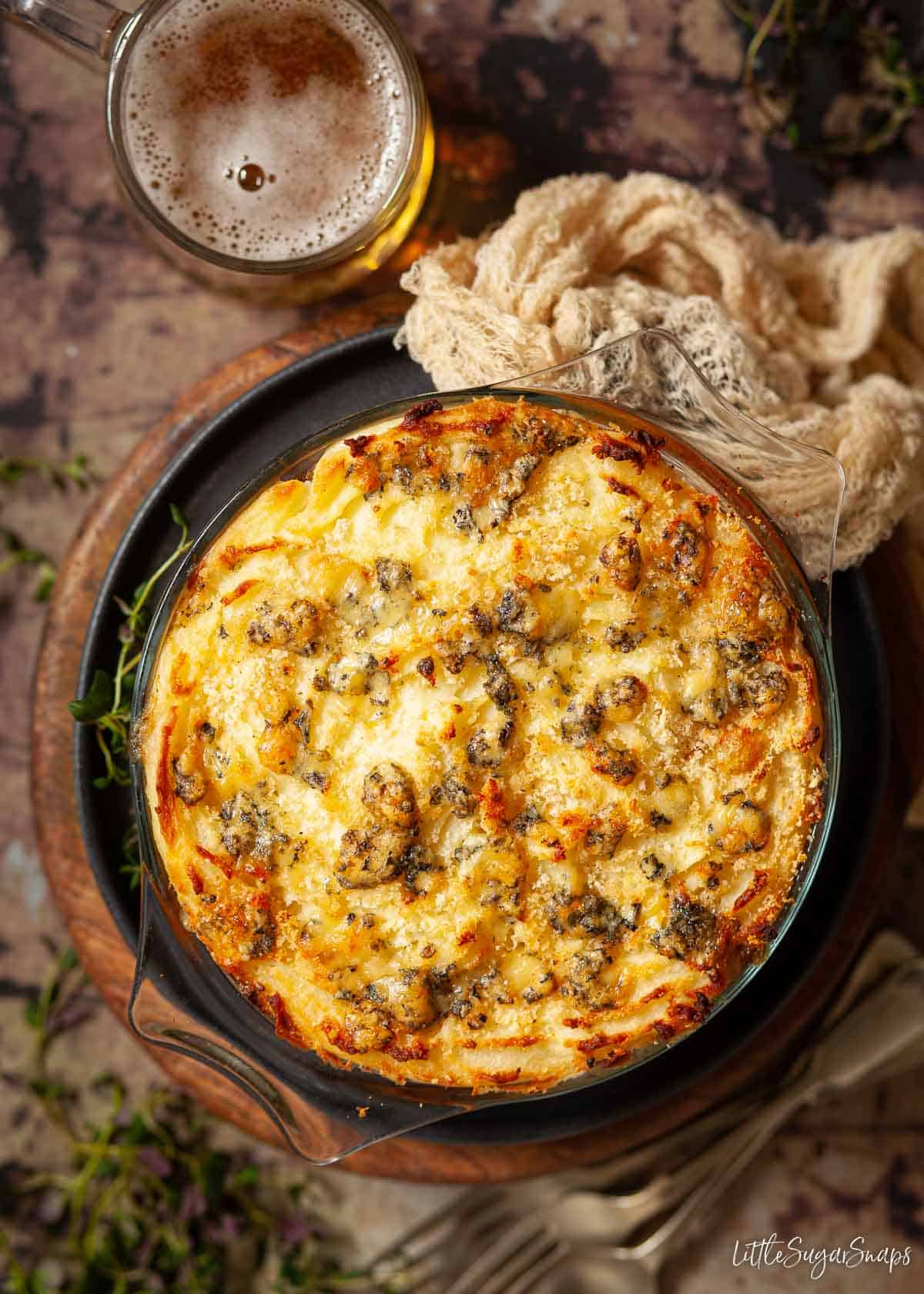 A dish of steak and stilton pie topped with mashed potato.