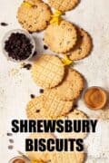 Lots of Shrewsbury biscuits on a worktop with ingredients nearby and text overlay.