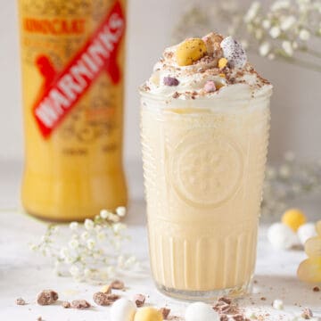 Close up of al advocaat milkshake drink with cream and Easter mini eggs.