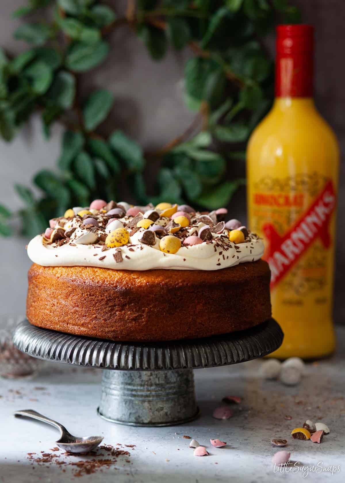 Advocaat dessert cake with a bottle of liqueur behind it.