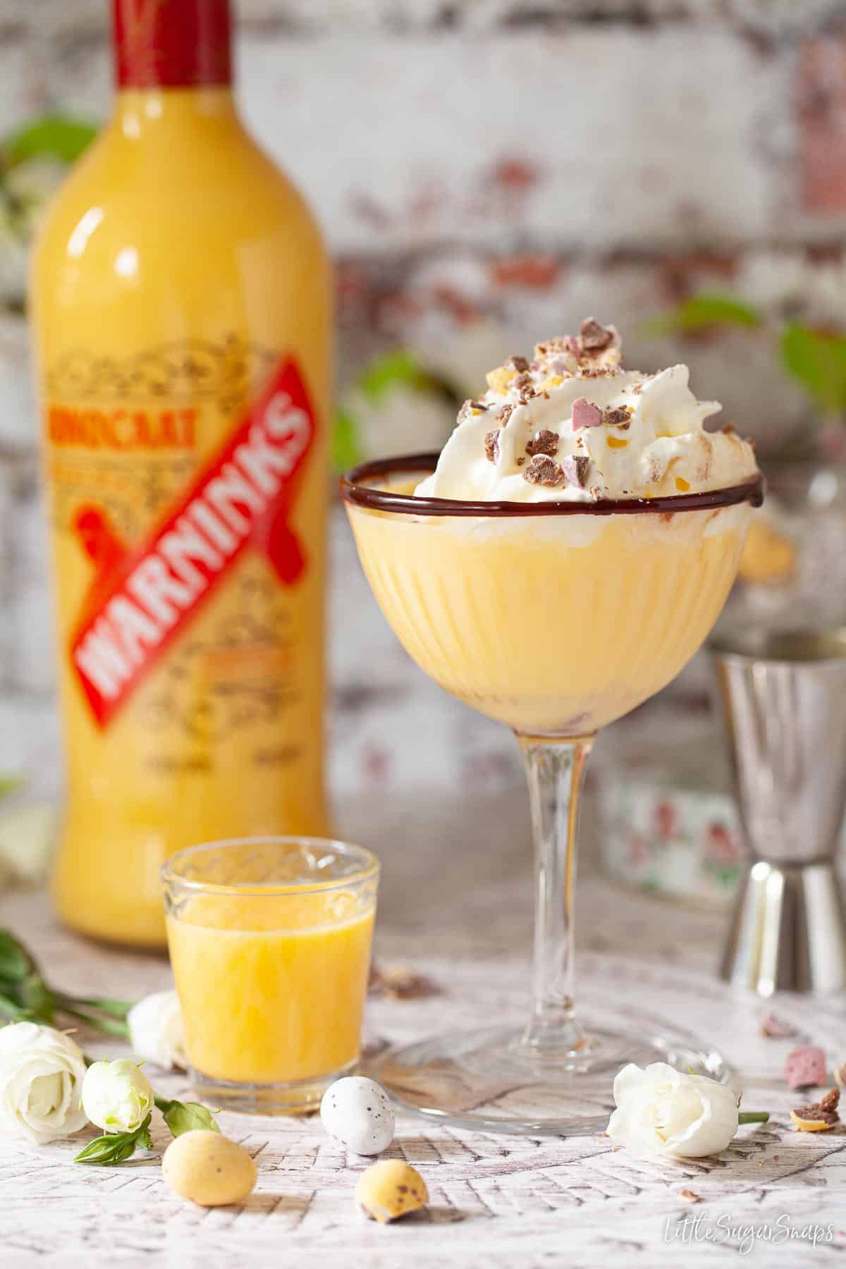 An Easter cocktail made with advocaat and garnished with cream and candy eggs.