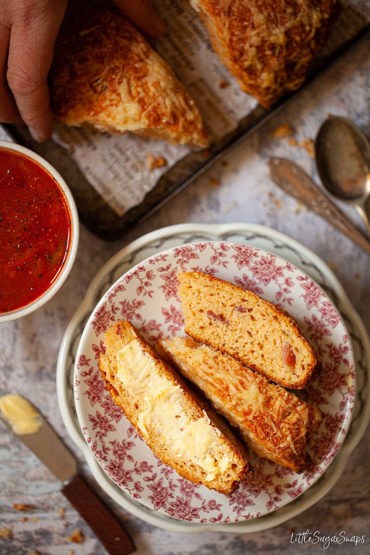 A Brummie bacon cake cut into pieces and spread with butter.