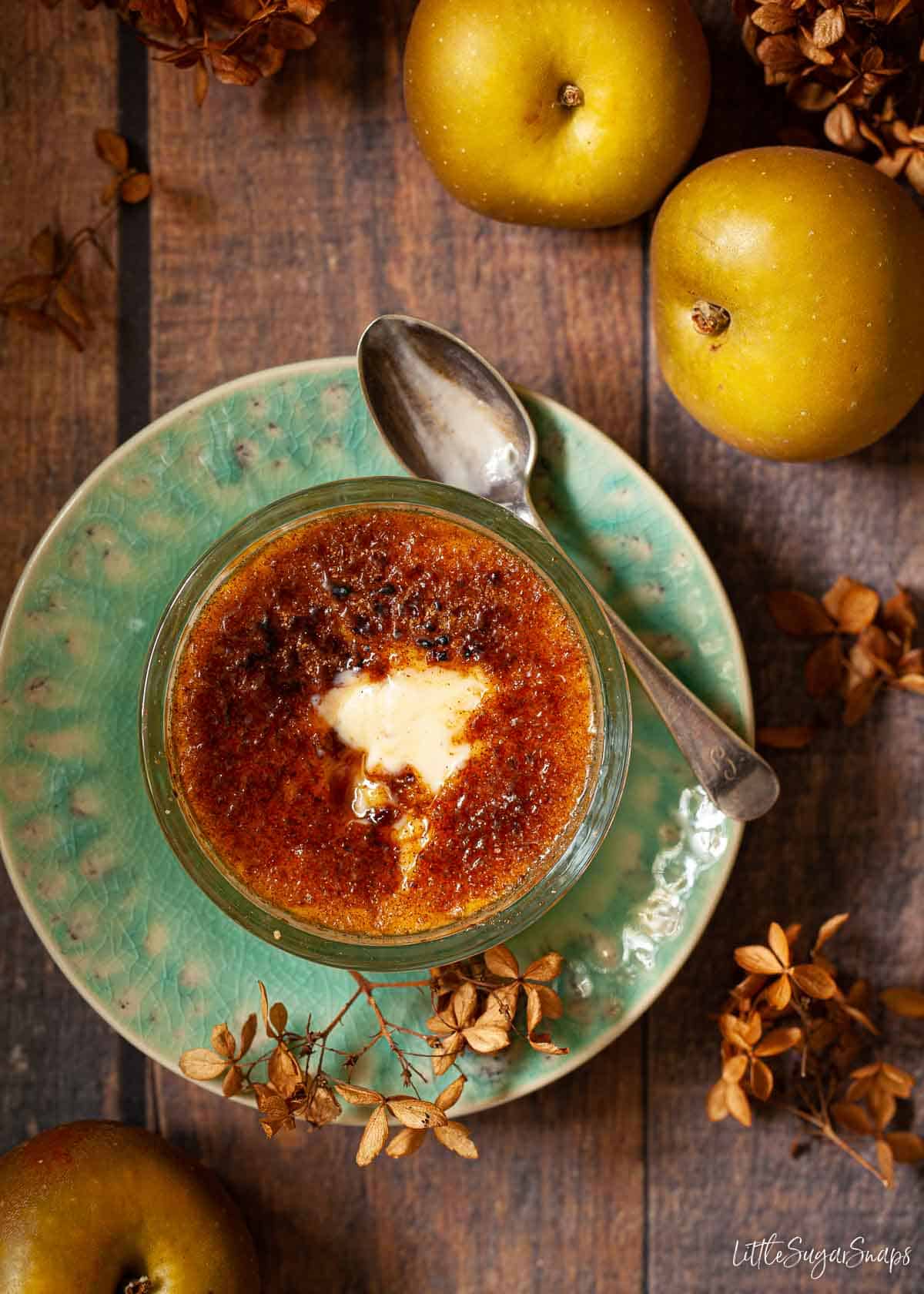 Individual serving of an English apple pudding with custard.