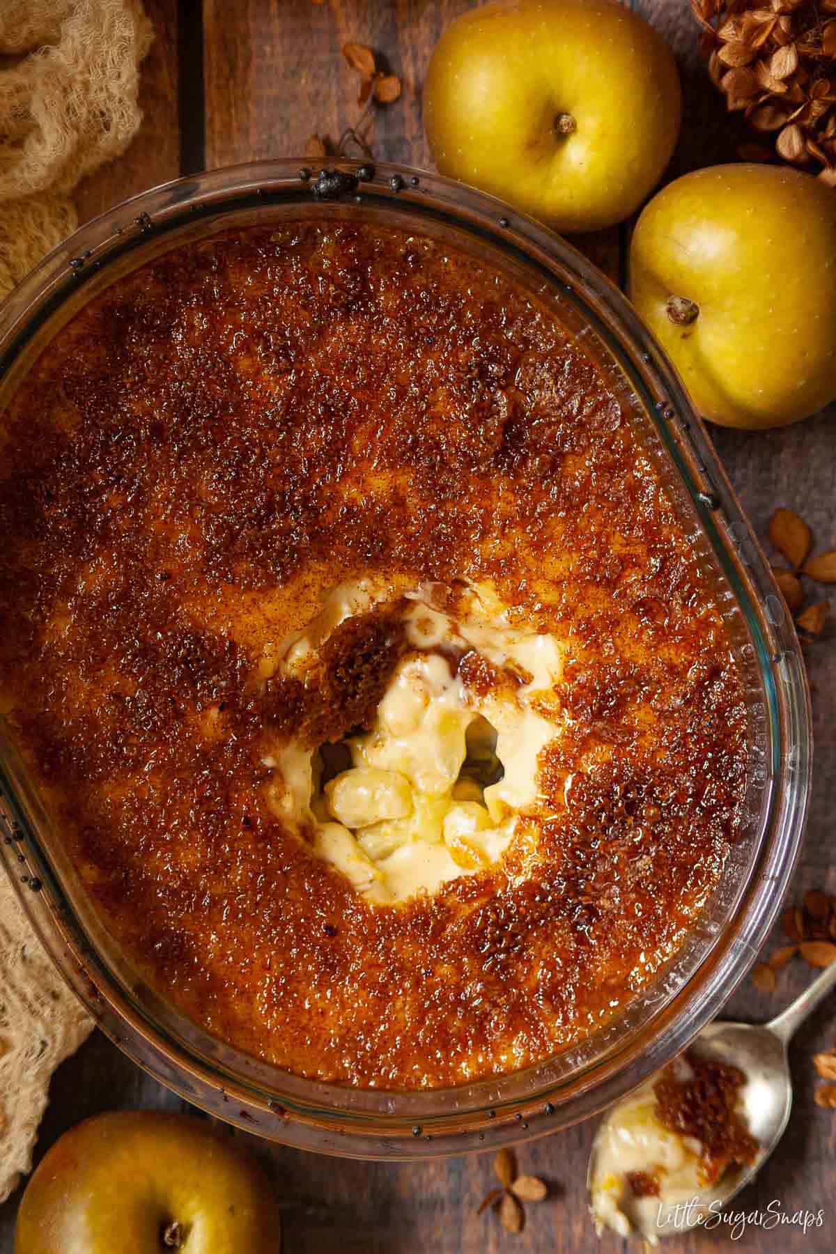 A bowl of Malvern pudding containing apples, custard and a crunchy sugar topping.