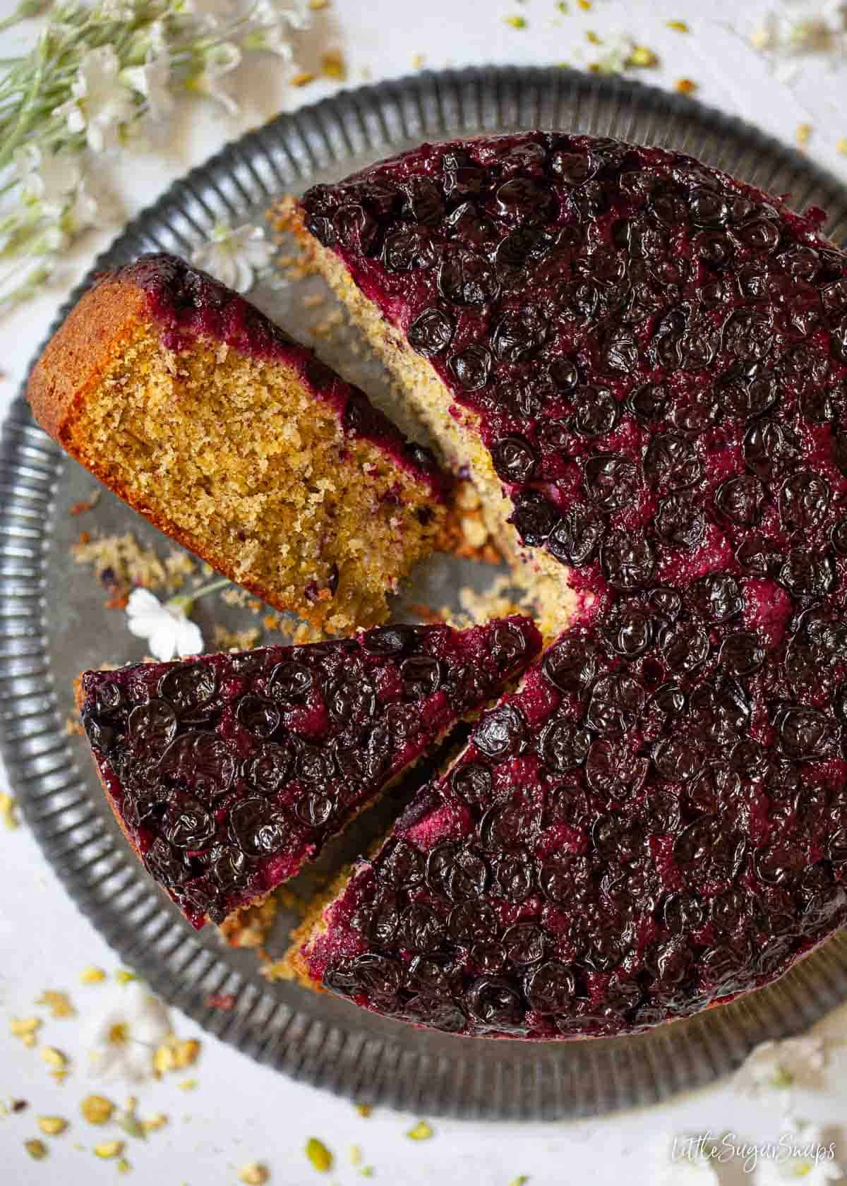 A blackcurrant cake with slices cut out of it.