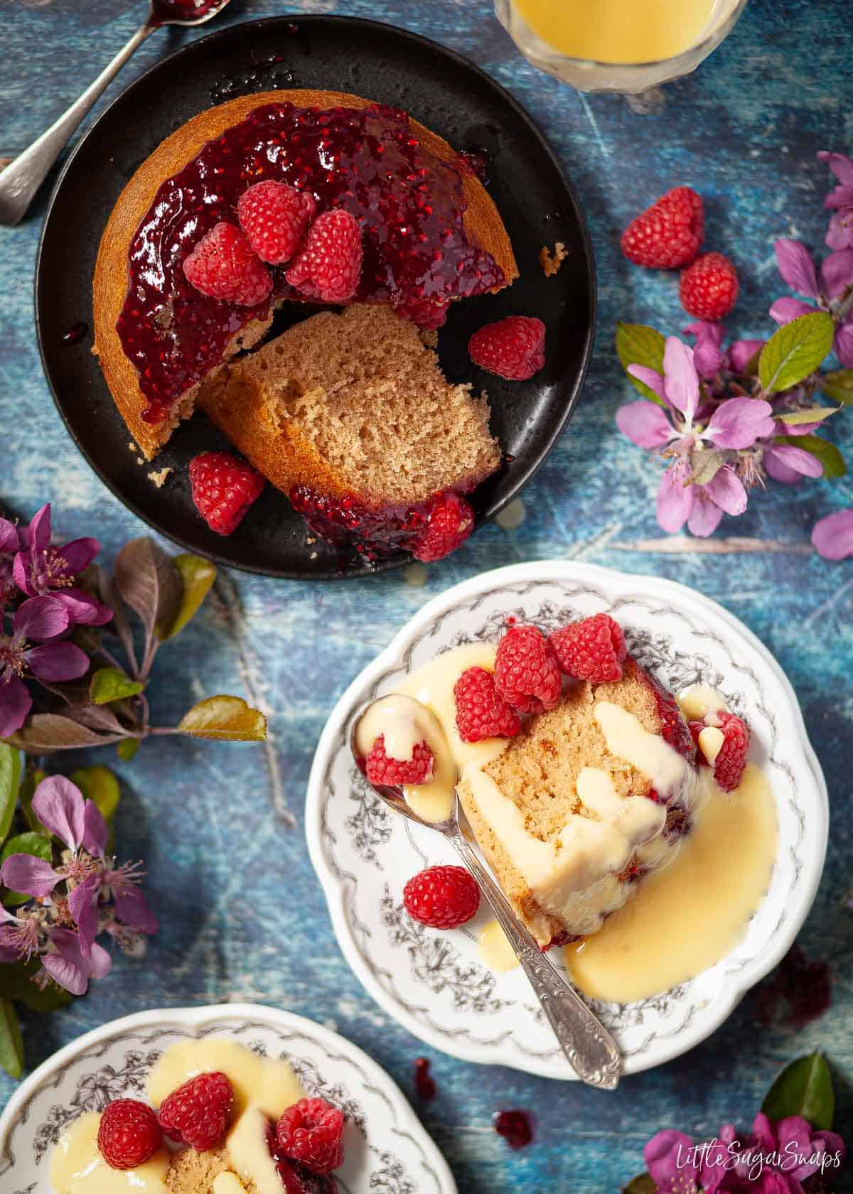 Northamptonshire pudding (steamed sponge pudding with jam) being served on plates with custard.