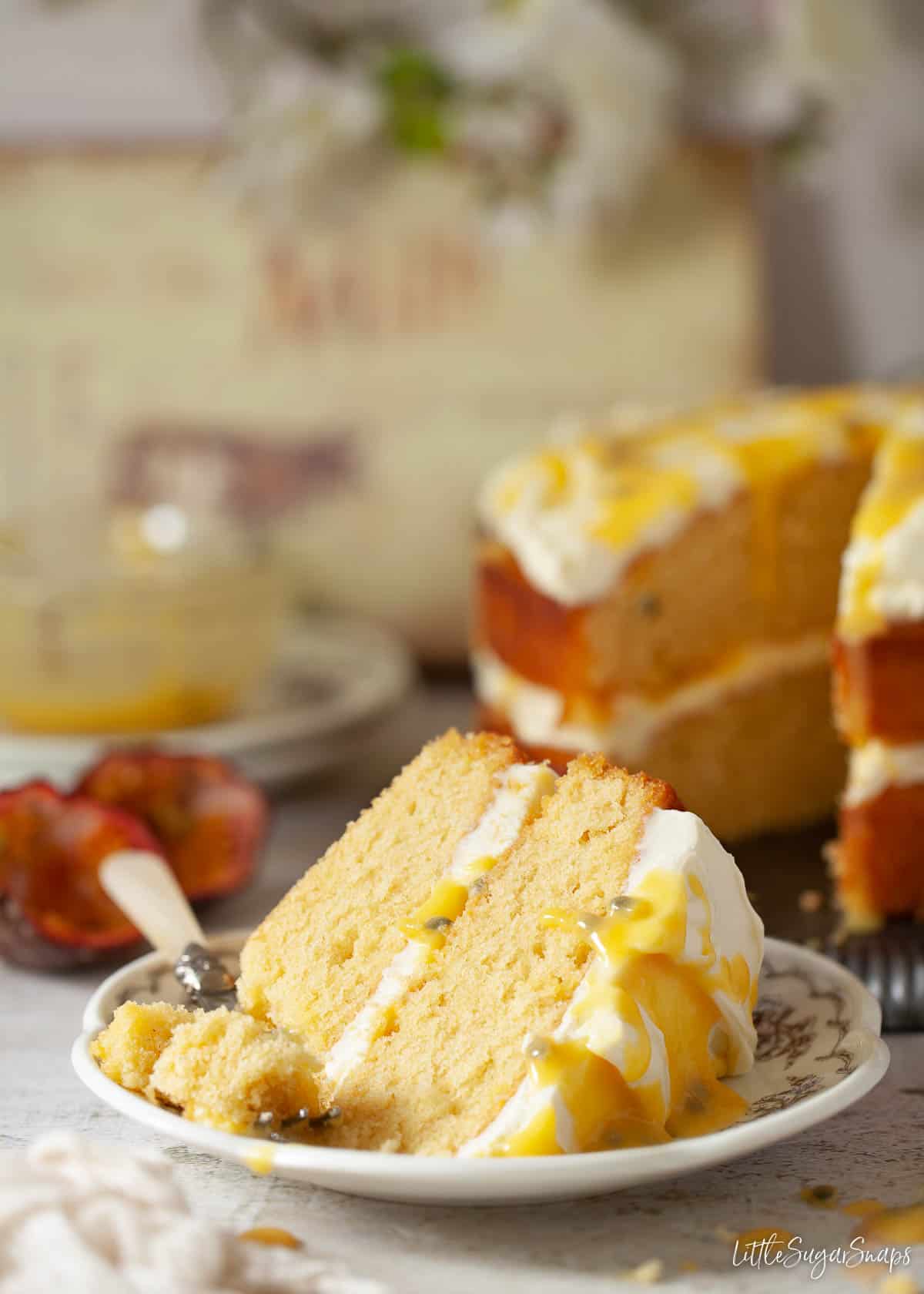 A slice of sponge cake with mascarpone cream topping and fruit curd.