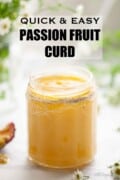 A jar of passion fruit curd in a jar with the lid off with text overlay.