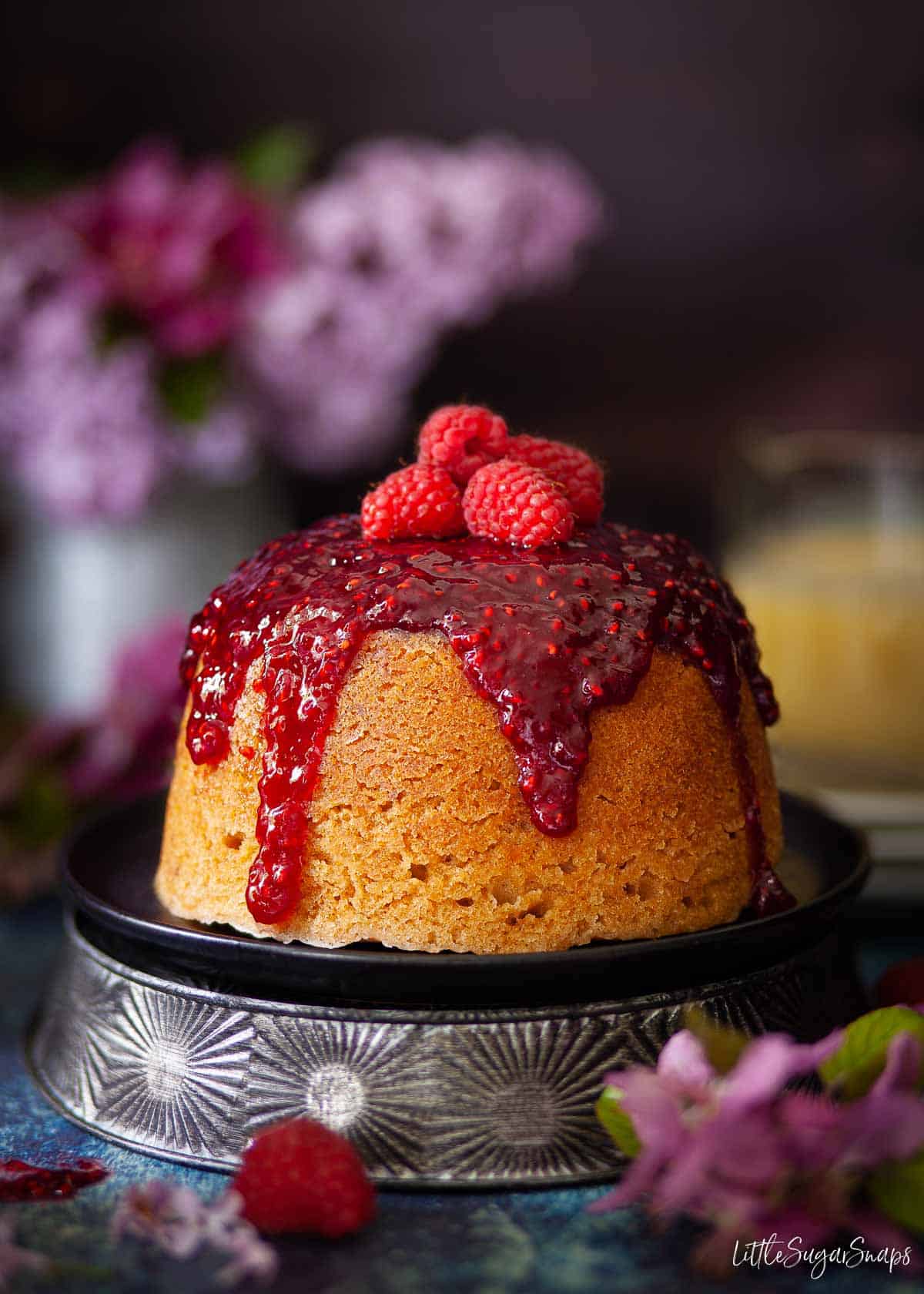 Steamed Jam and Sponge Pudding topped with fresh raspberries.