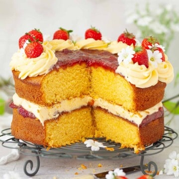 Close-up of a custard layer cake with a few slices removed.