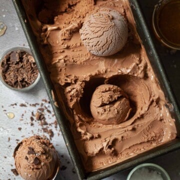 Close-up sea salt and dark chocolate ice cream in a metal tub.