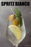 Spritz Bianco with lemon, rosemary and olive garnish with text overlay.