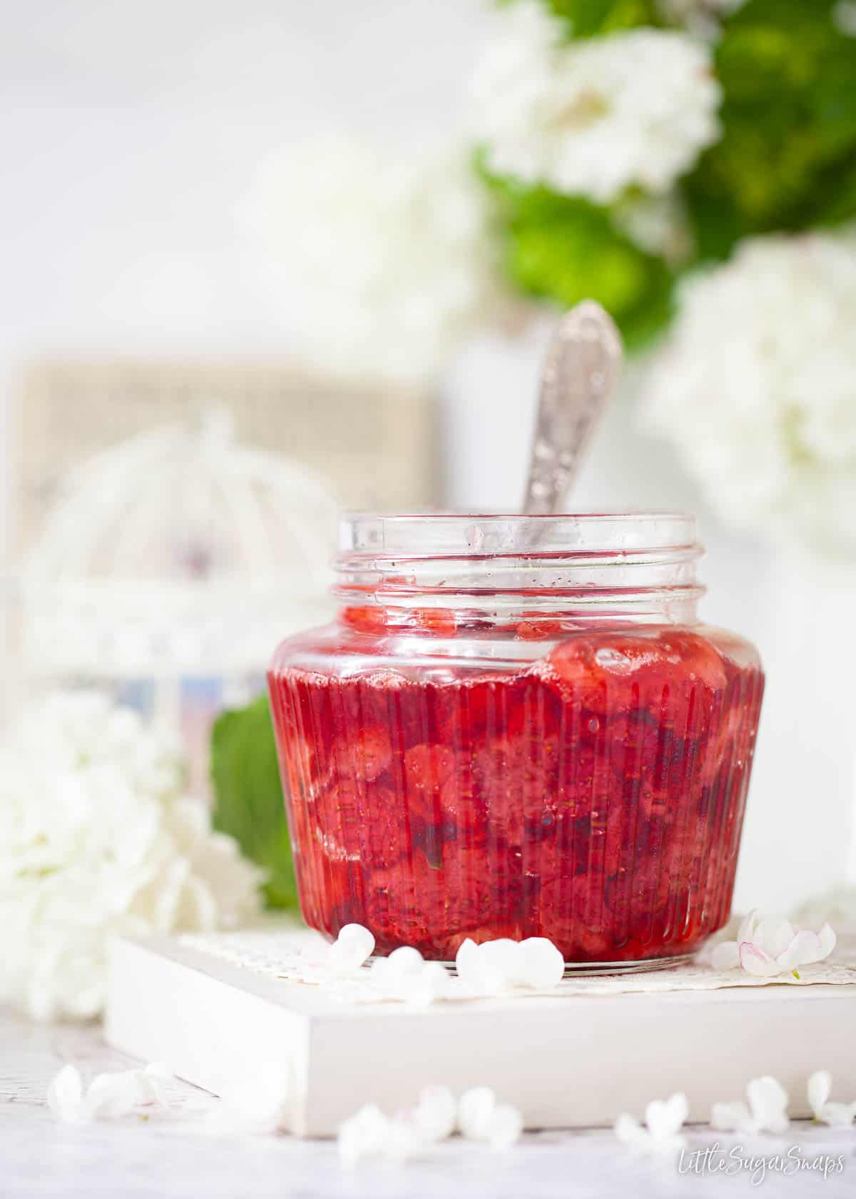 A jar of strawberry sauce.