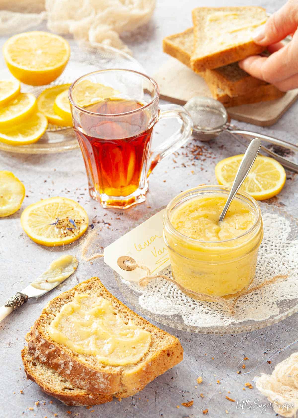 Lemon cheese being spread on toast.