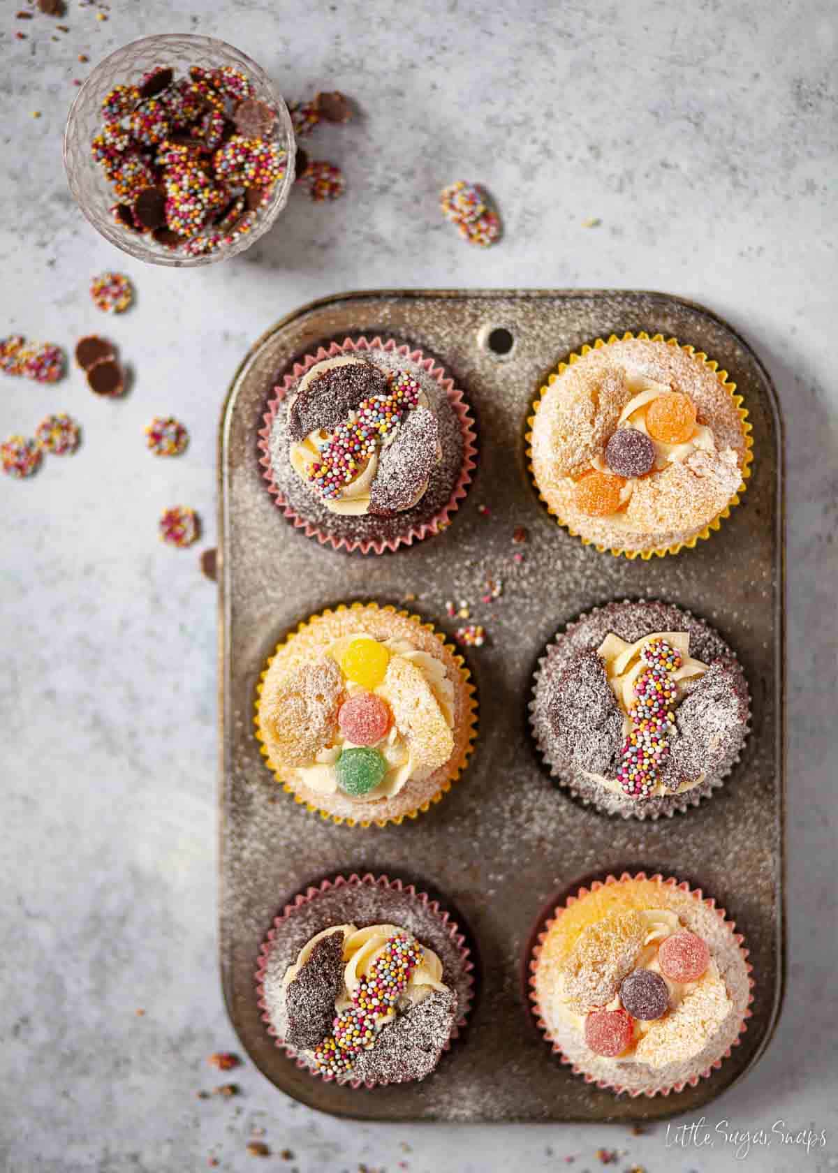 Vanilla and chocolate butterfly cakes in a baking tin.