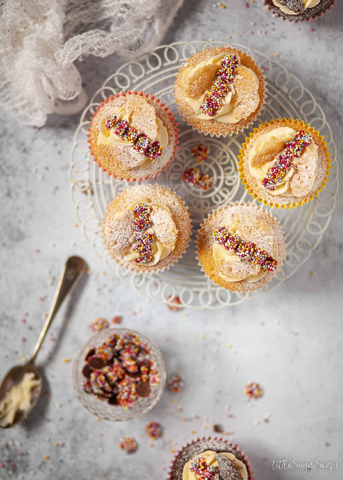 Vanilla butterfly cakes on a wire rack.