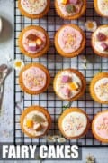 Small cakes on a wire rack. Decorated with water icing, sweets and sprinkles.