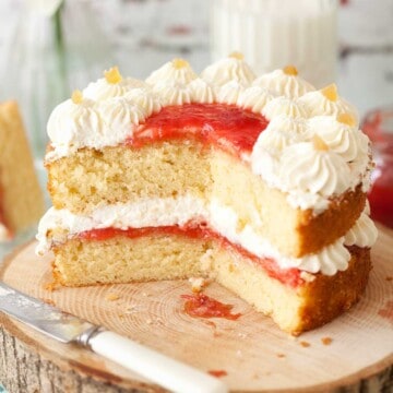 Close up of a vanilla sponge cake that has been cut into.