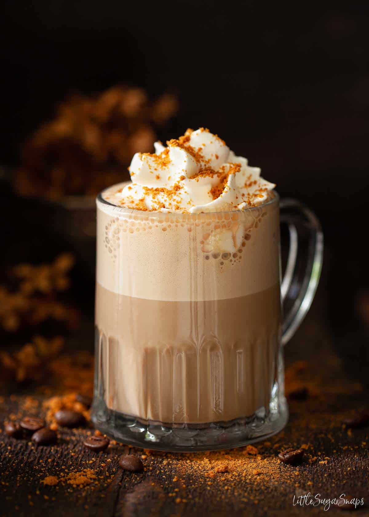 Biscoff coffee topped with whipped cream and crushed cookies.