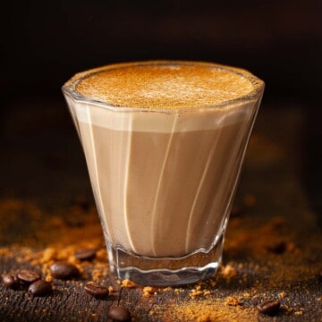 Close up of a Biscoff Latte in a coffee glass.