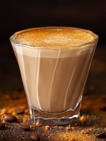 Close up of a Biscoff Latte in a coffee glass.