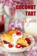 A slice of coconut tart with cream and fresh raspberries with text overlay.