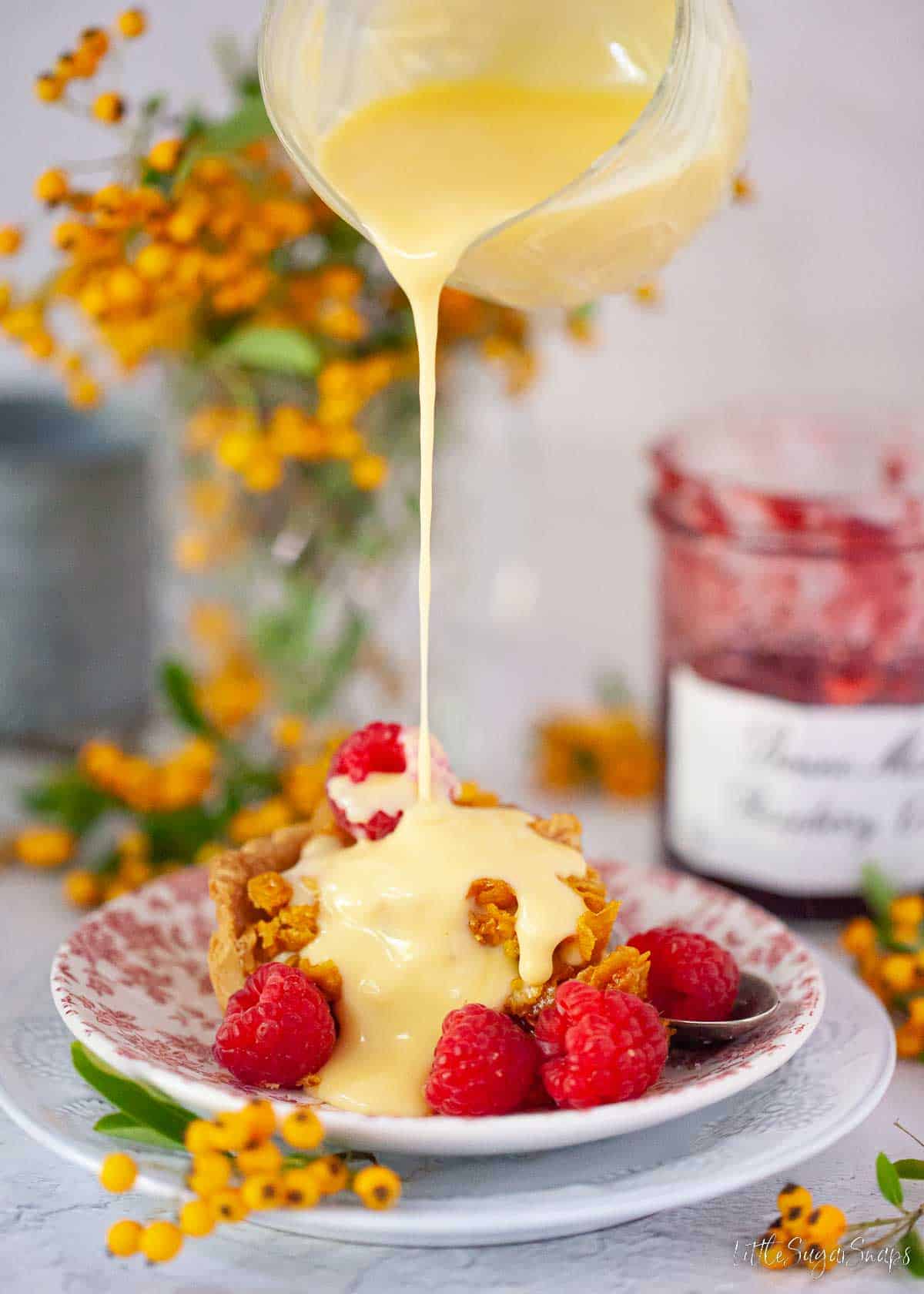 Custard being poured over a classic British childhood school pudding.
