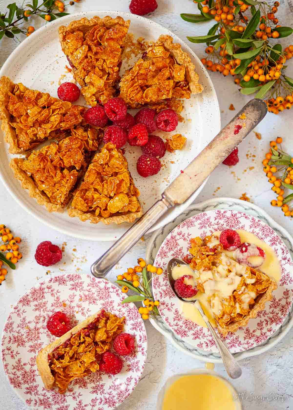 Classic treacle cornflake tart served with custard and fresh rapsberries.