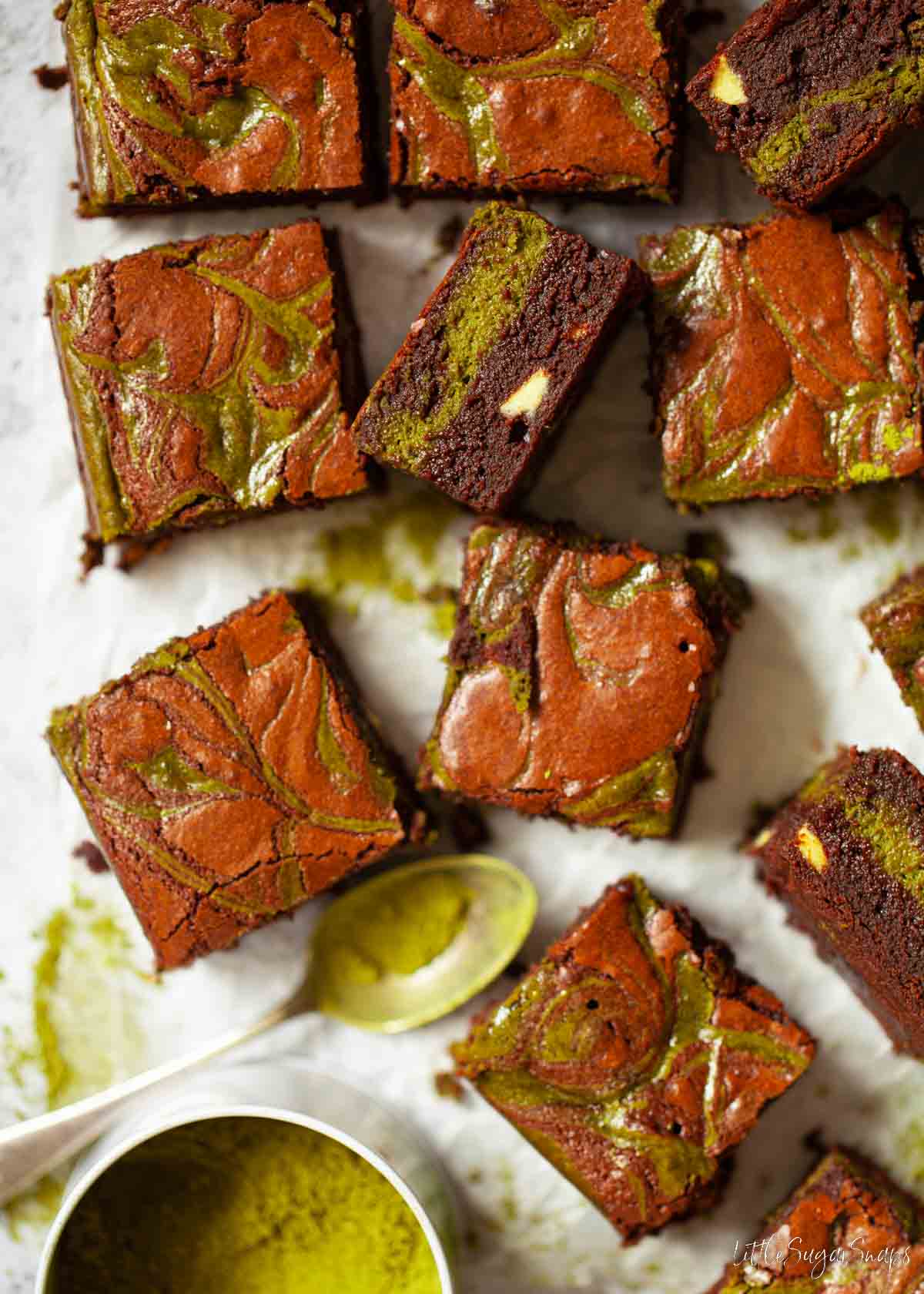 Squares of fudgy matcha brownies on a worktop.