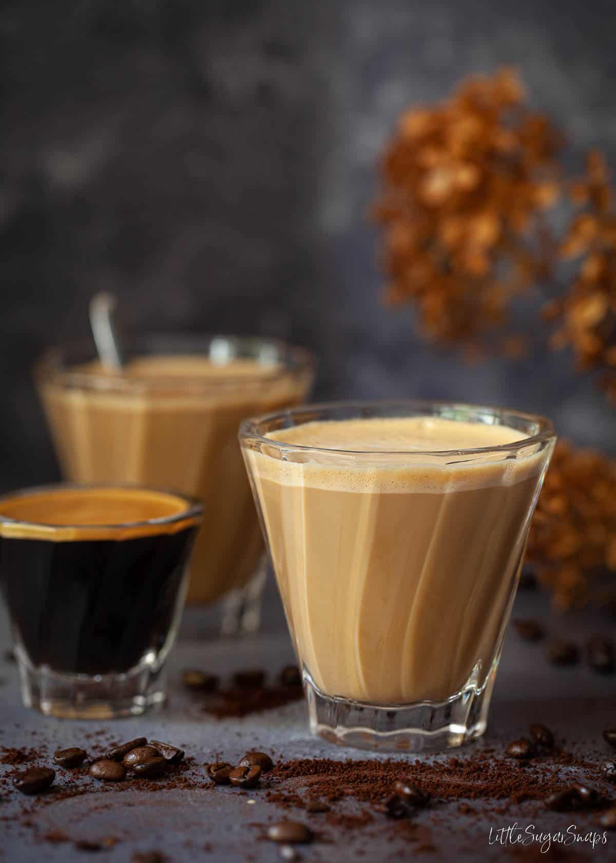 Glasses of Spanish latte and an espresso coffee shot.