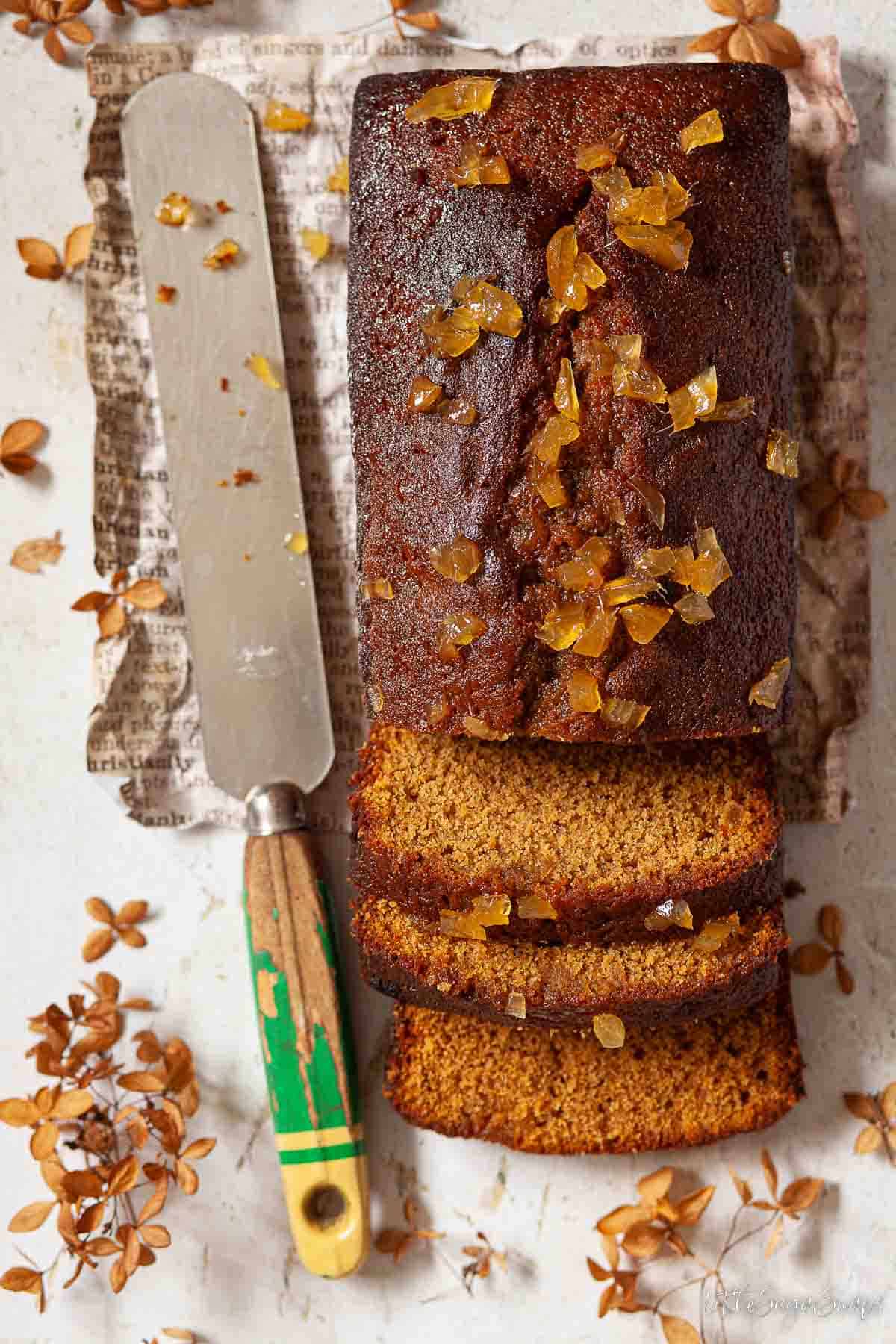 Stem ginger cake cut into with a knife by the side.