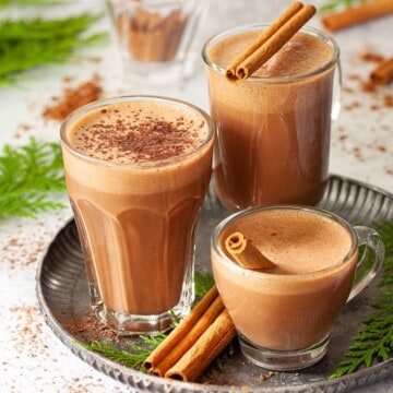 Three servings of healthy hot chocolate in mixed glasses.