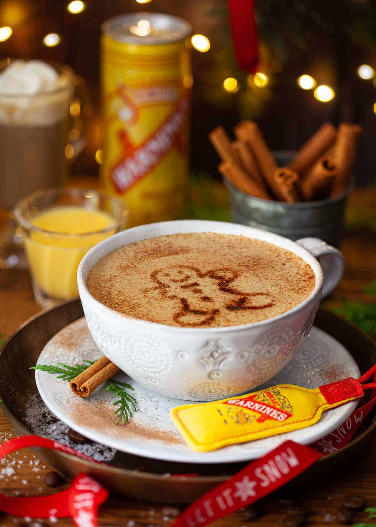 Christmas latte in a mug with a gingerbread man stencilled on the top.