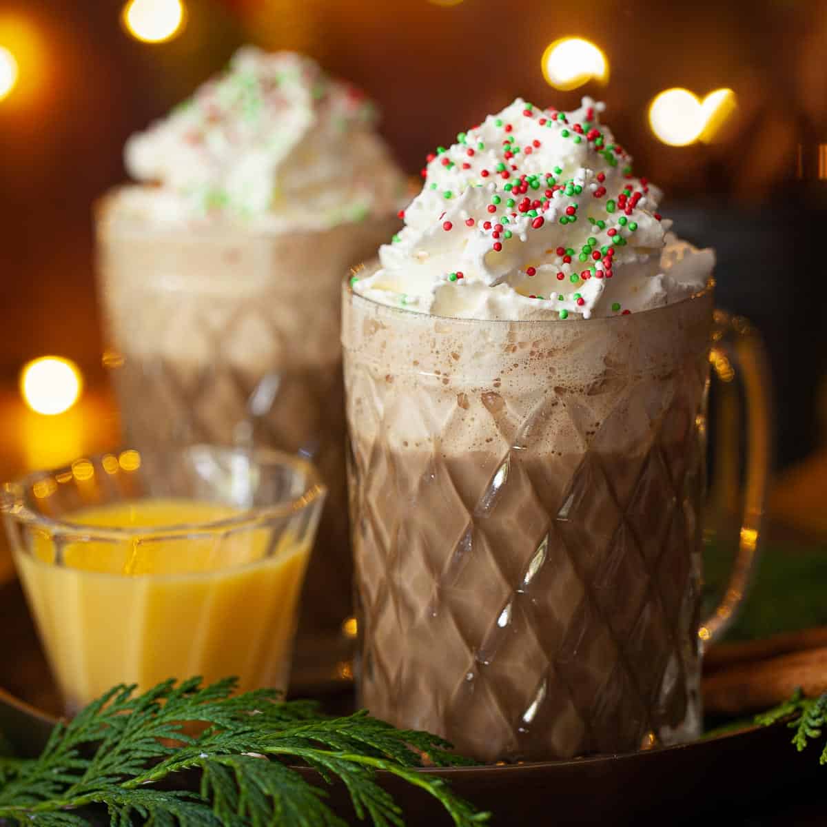 Close-up of Christmas latte with whipped cream and sprinkles.