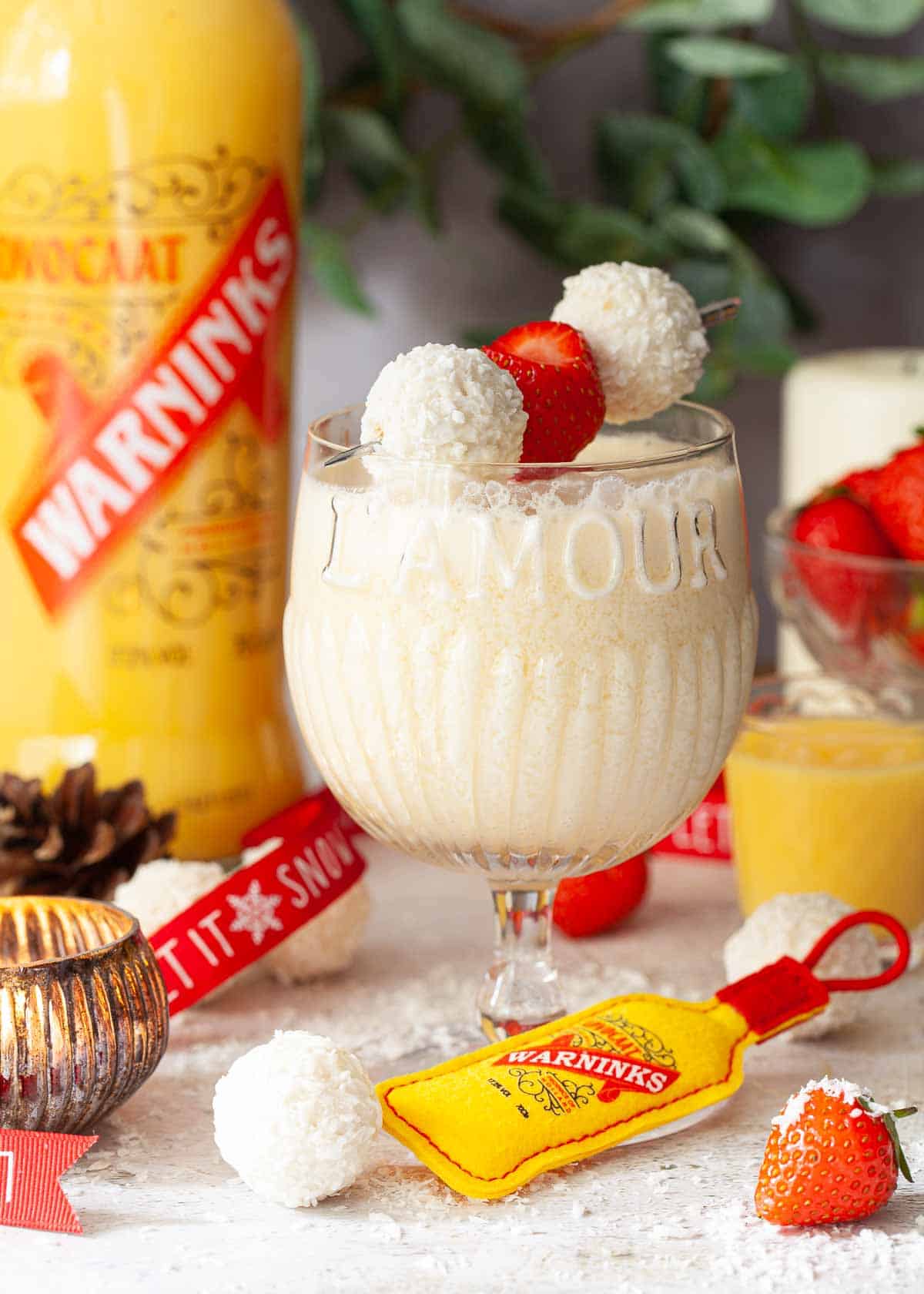 A fizzy fluffy duck cocktail eith rum and advocaat and garnished with chocolate and strawberries.