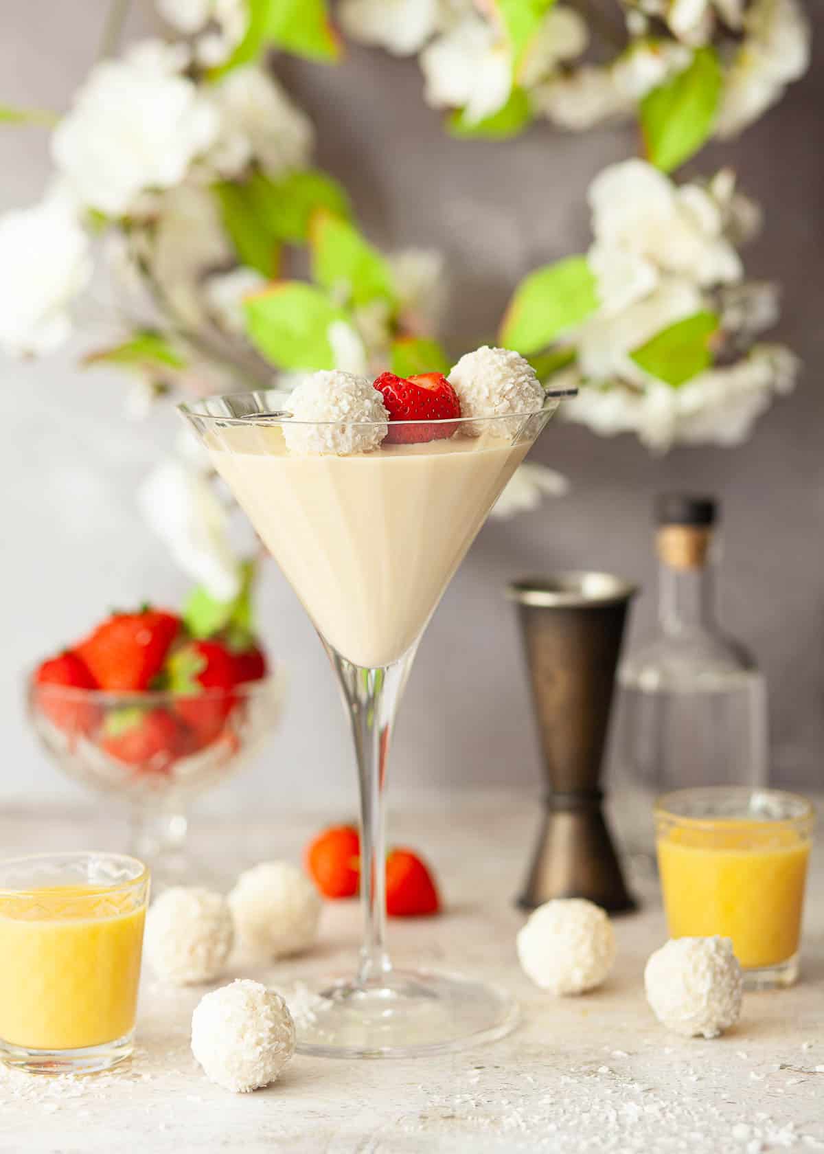 A creamy advocaat cocktail topped with chocolates and starwberries.