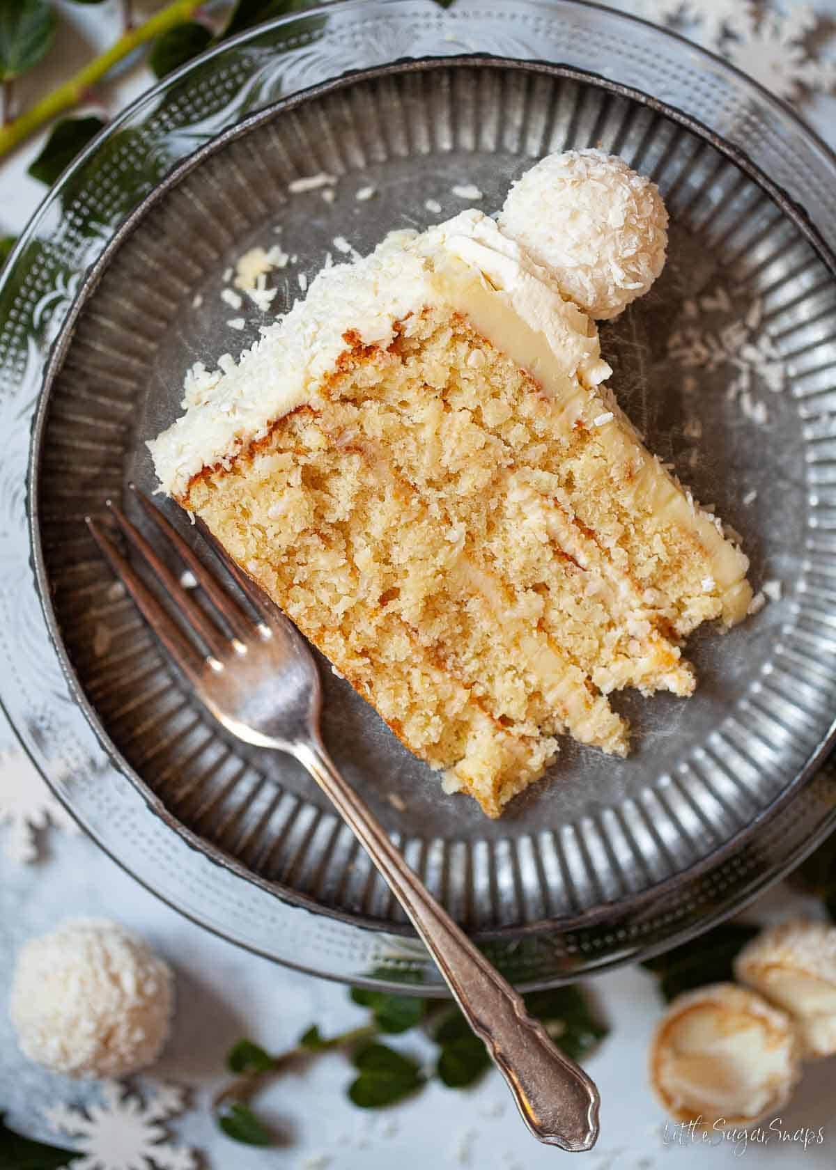 Close-up of a slice of white chocolate, coconut and almond torte.