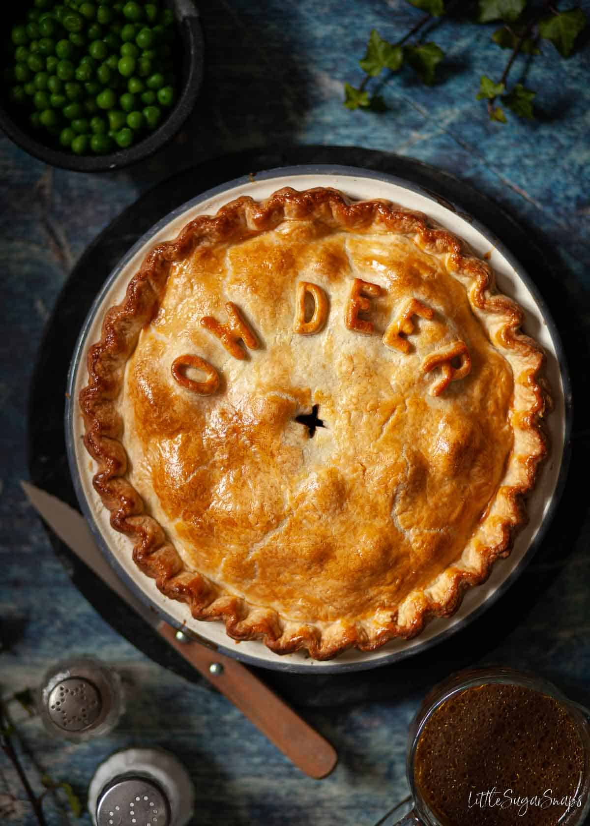 Shortcrust pastry venison pie with oh deer spelt on top in pastry letters.