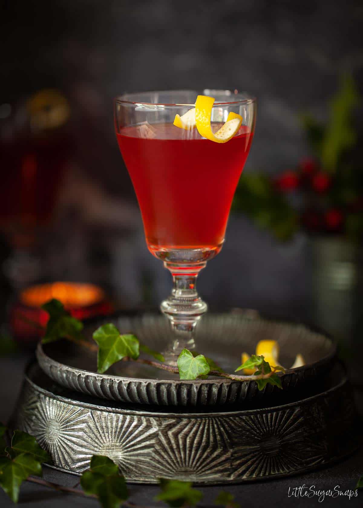 A close-up view of an Amaro Montenegro cocktail with a lemon twist garnish.