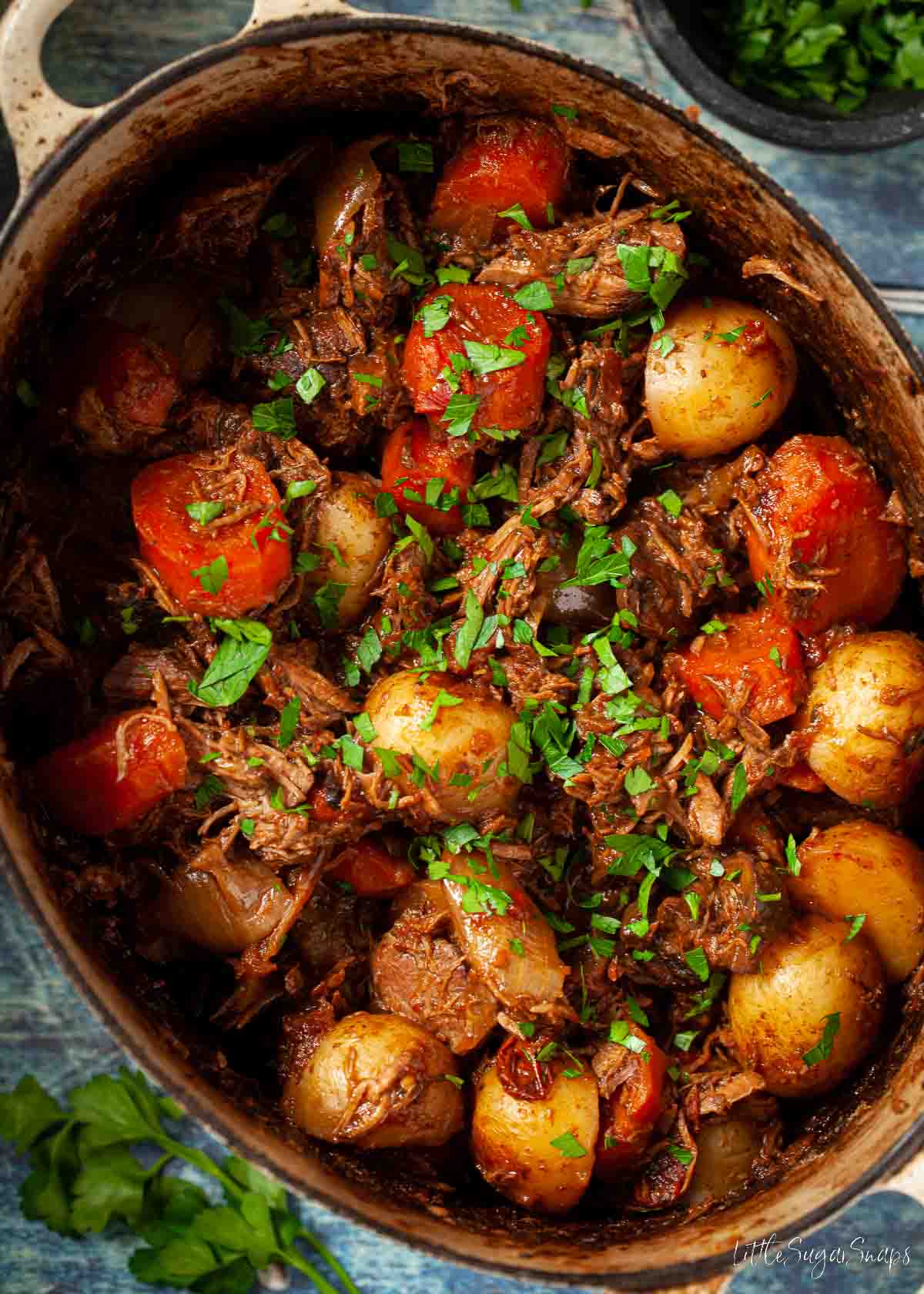 Beef stew with mushrooms in a cooking pot.