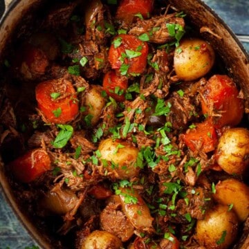 Close up of beef and mushroom stew in a cooking pot.