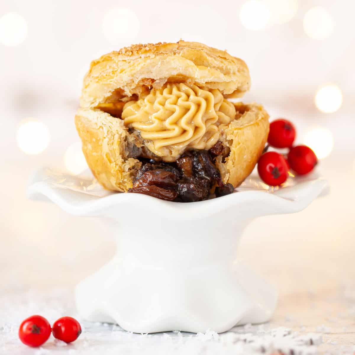 A mince pie filled with advocaat butter on a small stand.